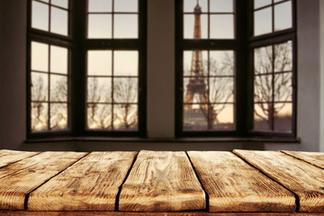 Dark wooden table of free space and window sill background with city landscape. 