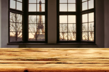 Dark wooden table of free space and window sill background with city landscape. 