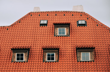 Rooftop of brick house with small windows