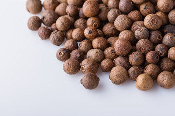 fresh spicy peppers allspice on white acrylic background
