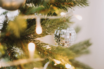 Christmas balls hanged on the Christmas tree branch.  Baubles and branch of spruce tree. Christmas and New Year background