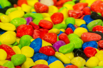 colored stones. Abstract background of many colored stones. Selective focus.