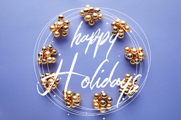 round frame of shiny golden Christmas decoration on blue background with Happy holidays lettering