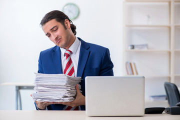 Young male businessman sitting in the office