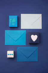 Blue envelopes, gifts and white hearts on classic blue