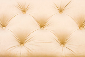 Textural rhomb pattern in light upholstery. Front view. Close up.