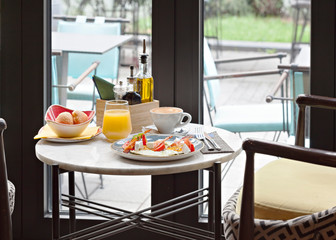 Delicious breakfast with eggs and bacon served in restaurant