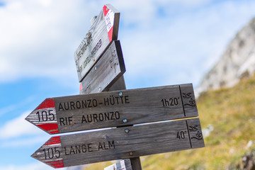 Wooden signpost for hikers in the Dolomites, Italy