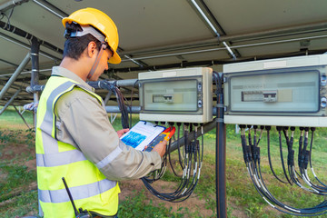 Portrait of engineer man or worker, people, with solar panels or solar cells on the roof in farm....