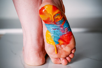 Foot painted with multi-colored acrylic paint