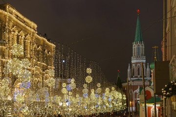 Bright illuminated Red Square, facade of the GUM (Central Department store) and Spasskaya Tower in Moscow. Lighting of the Red Square during winter night.