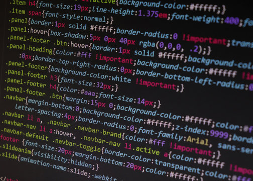 Close up css code on monitor screen with black background