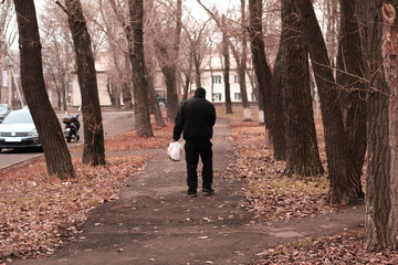 a man walks through the city rear view