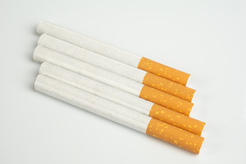 Close up of group of unlit cigarettes isolated on a white background