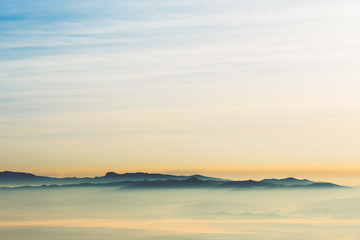 Landscape images of the complex mountains Floated out of the mist in the morning while the sun began to rise from the horizon, beautiful nature background to travel concept.