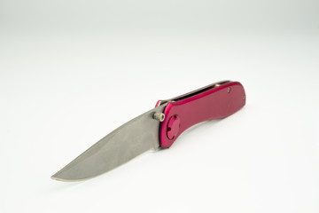Close up of pink colour knife, isolated on white background