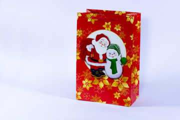 red christmas gift bag with tinsel