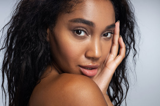 Beautiful Afro-American woman is posing in studio