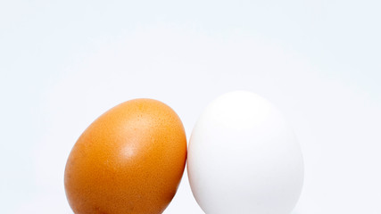 Two isolated eggs of yellow and white color. close up on a white background.