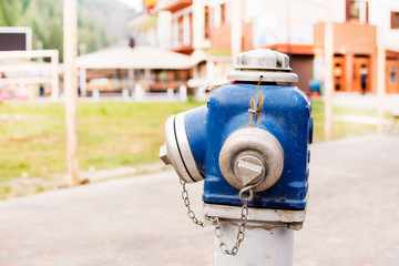Blue fire hydrant. Beautiful sky behind hydrant.