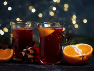 Two glasses of traditional Christmas and winter hot drink mulled wine of red wine with cinnamon, anise, berries and orange
