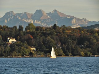Geneva, Switzerland - October 18th 2019: a Beautiful autumn day in Lake Leman in Geneva. The Lake is surrounded by beautiful mountain that makes the sailing even more spectacular for the many sailors