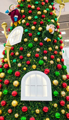 Big Christmas tree with red, yellow, green balls, Windows, and dwarfs are gnome
