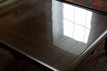 Window reflection on the glass top coffee table