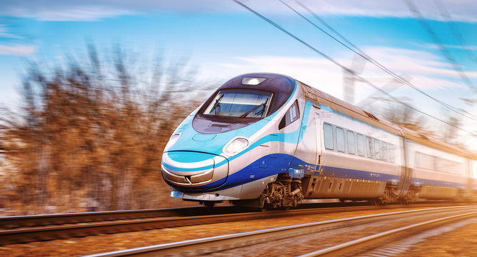 Modern high speed aerodynamic streamlined electric train passing by.