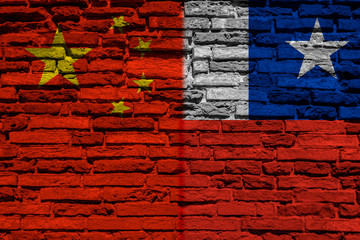 Flag of China and Chile on brick wall