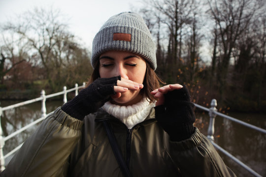 Woman In Winter Forest With Common Cold