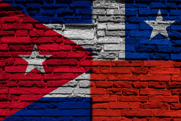 Flag of Cuba and Chile on brick wall