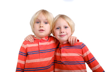 Two caucasian boys brothers posing in studio