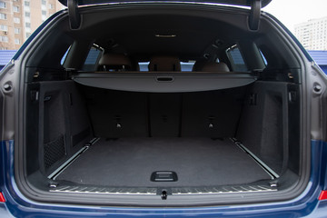 empty roomy open trunk of modern crossover car, copy space, Rear view of a car with an open trunk,...