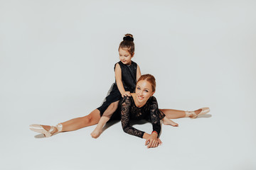 Fototapeta na wymiar ballroom dance teacher and little child is dancing in a bright hall dance studio. dance classes. 