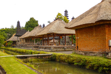 Fototapeta na wymiar The beautiful buildings of the royal family temple in Bali separated by a river of water. Indonesia