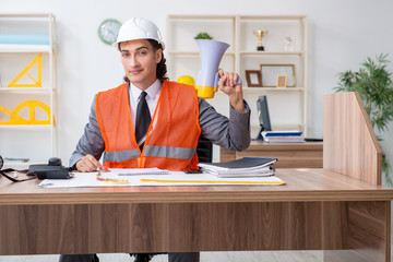 Young male architect working in the office