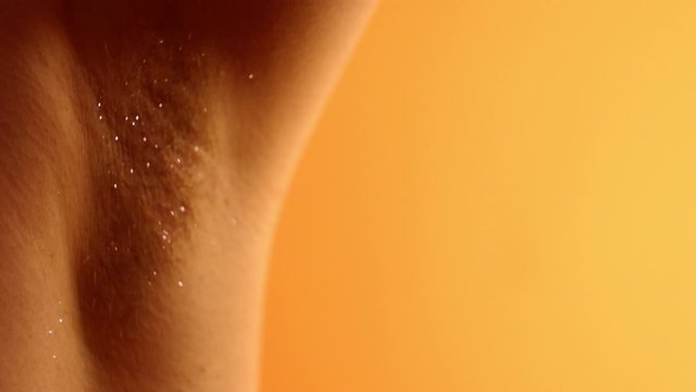 Close up body hair with pink glitter. Body positive concept. Woman beauty. Woman with hairy armpit. Depilation. Woman rights