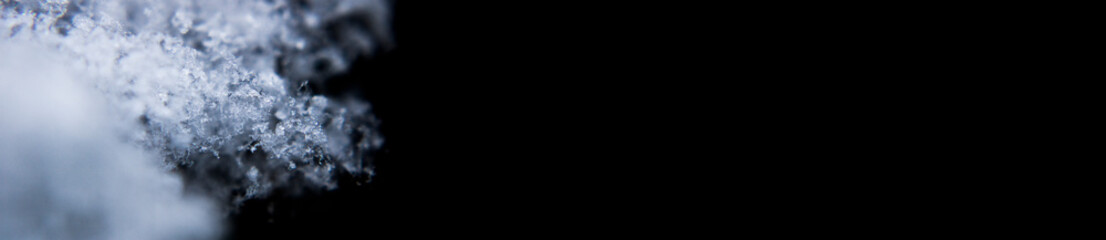 Seasonal Snow Snowflake Ice Crystal Photo Banner with a Dark Background  