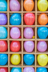 Background of multicolored real balloons in a row close-up. Pattern of leisure activity and happiness concept.