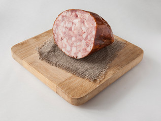 Meat cutting on a board, lard on white background. Top view