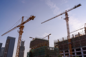 cranes operating at a high altitude in a construction site of shenzhen china