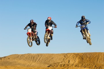 Motocross Male Racers Racing Against Sky