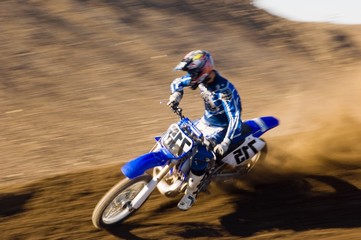 Motocross Racer Riding Motorcycle On Dirt Track