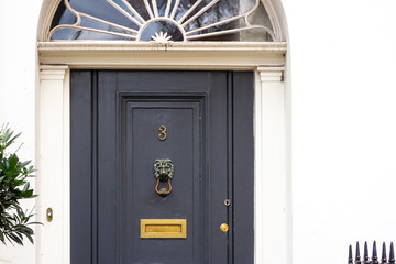 Beautiful wooden front door with the house number 3