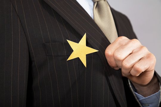 Businessman With Gold Star On Suit
