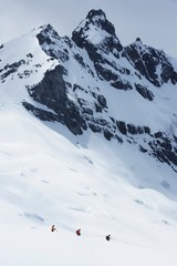 Fototapeta na wymiar Hikers Heading For Distant Peak In Snow