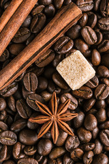 Coffee beans, anise star, cinnamon sticks and brown sugar, background, close-up