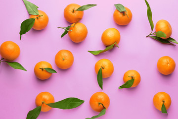 Sweet tangerines on color background