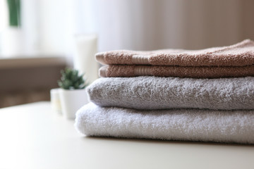 a stack of fresh towels on the table.